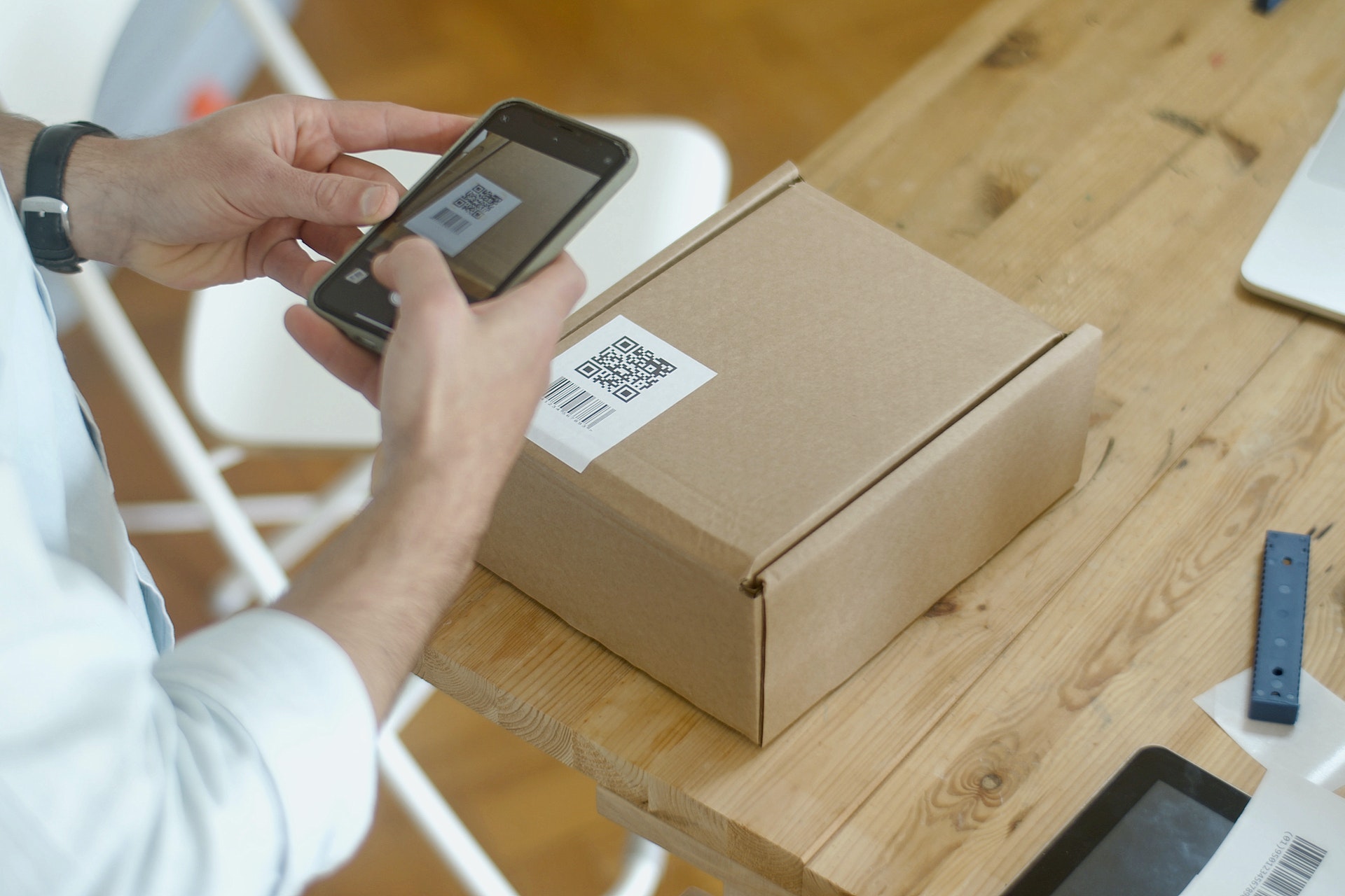 Man scanning returns QR code on a box